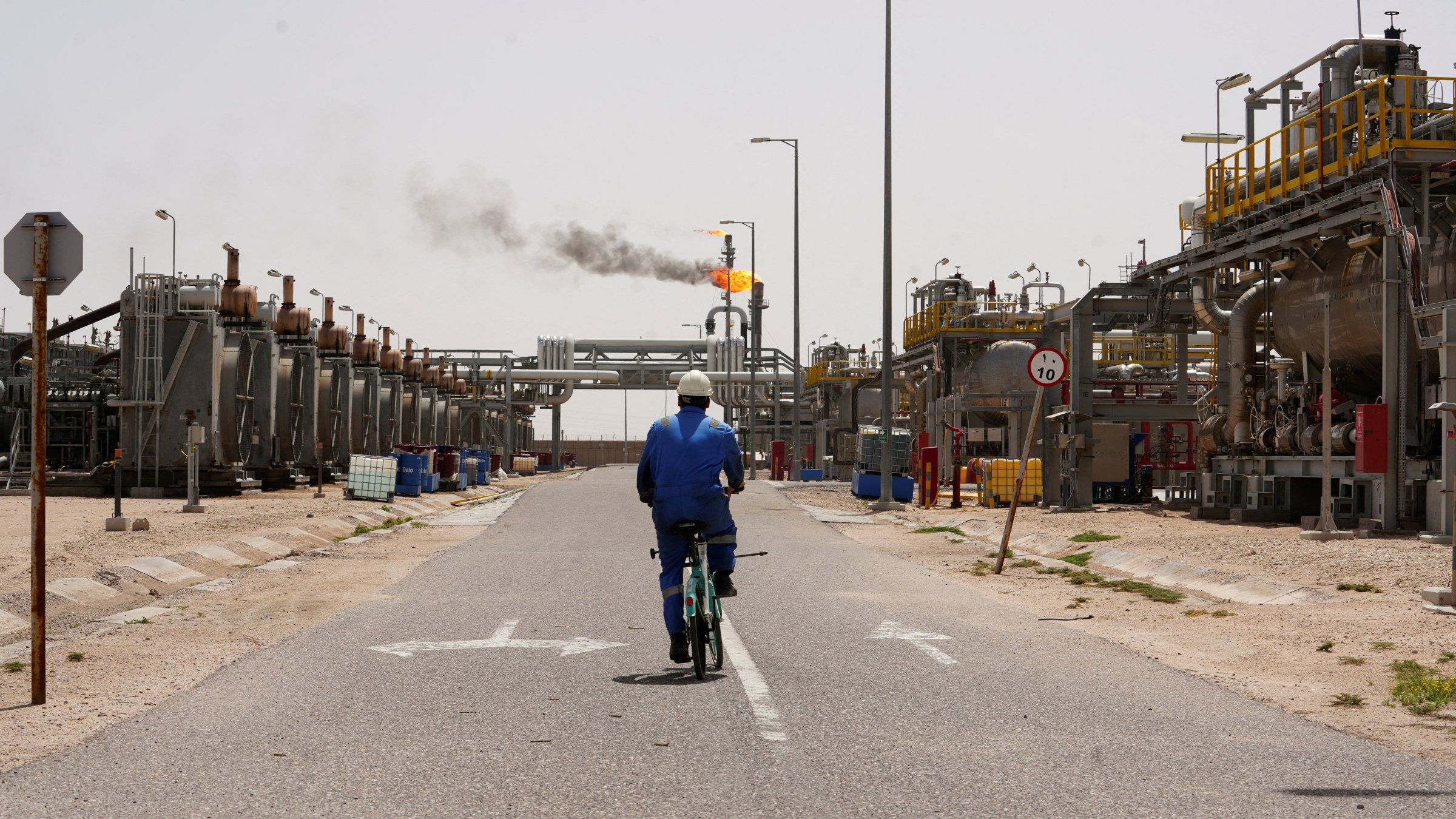 A worker rides a bicycle at the Zubair oil field in Basra, Iraq, April 6, 2026. (Reuters Photo)
