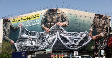 Cars drive near an anti-U.S. billboard, amid the U.S.-Israeli conflict with Iran, Tehran, Iran, April 5, 2026. (Reuters Photo)