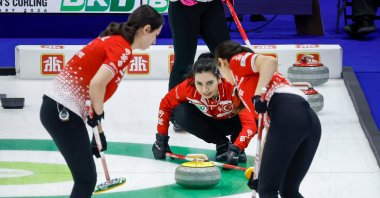 Türkiye's skip Dilşat Yıldız (C) directs her teammates, second Iclal Karaman (R) and lead Berfin Şengül against Japan during qualifying at the World Women's Curling Championship, Calgary, Canada, March 21, 2026. (AP Photo)