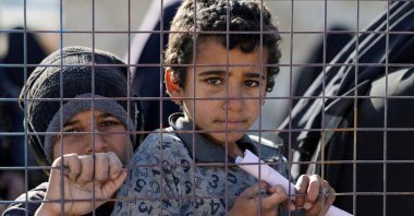 Children, part of a group of detainees, look through a fence at the al-Hol camp after the Syrian government took control of it, Hassakeh, Syria, Jan. 21, 2026. (Reuters Photo)