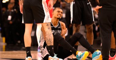 San Antonio Spurs' Victor Wembanyama grabs his left arm after an injury during a game against the Philadelphia 76ers in the first half at Frost Bank Center, San Antonio, U.S., April 6, 2026. (AFP Photo)