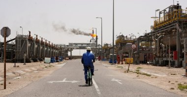 A worker rides a bicycle at the Zubair oil field in Basra, Iraq, April 6, 2026. (Reuters Photo)
