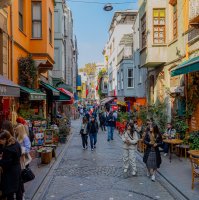 People walk on a historic street of the Balat district known for its colorful buildings, Istanbul, Türkiye, Nov. 2, 2024. (Shutterstock Photo)