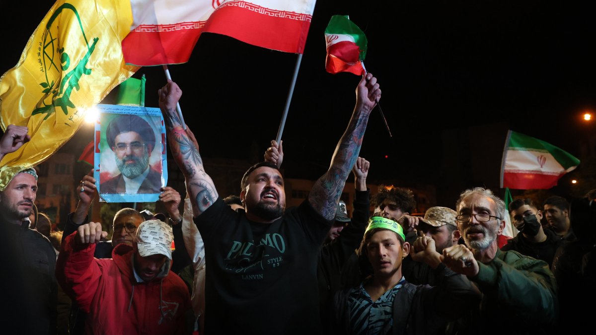 Iranians wave the country's flag and hold a portrait of Supreme Leader Mojtaba Khamenei following the announcement of a two-week cease-fire at in Tehran, Iran, April 8, 2026. (EPA Photo)