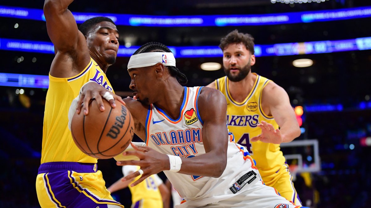 Oklahoma City Thunder's Shai Gilgeous-Alexander (C) moves the ball against Los Angeles Lakers forward Rui Hachimura (L) during the second half at Crypto.com Arena, Los Angeles, U.S., April 7, 2026. (Reuters Photo)