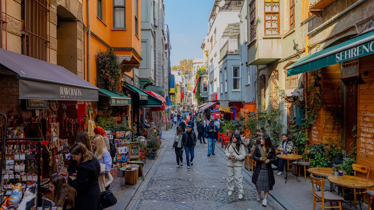 People walk on a historic street of the Balat district known for its colorful buildings, Istanbul, Türkiye, Nov. 2, 2024. (Shutterstock Photo)