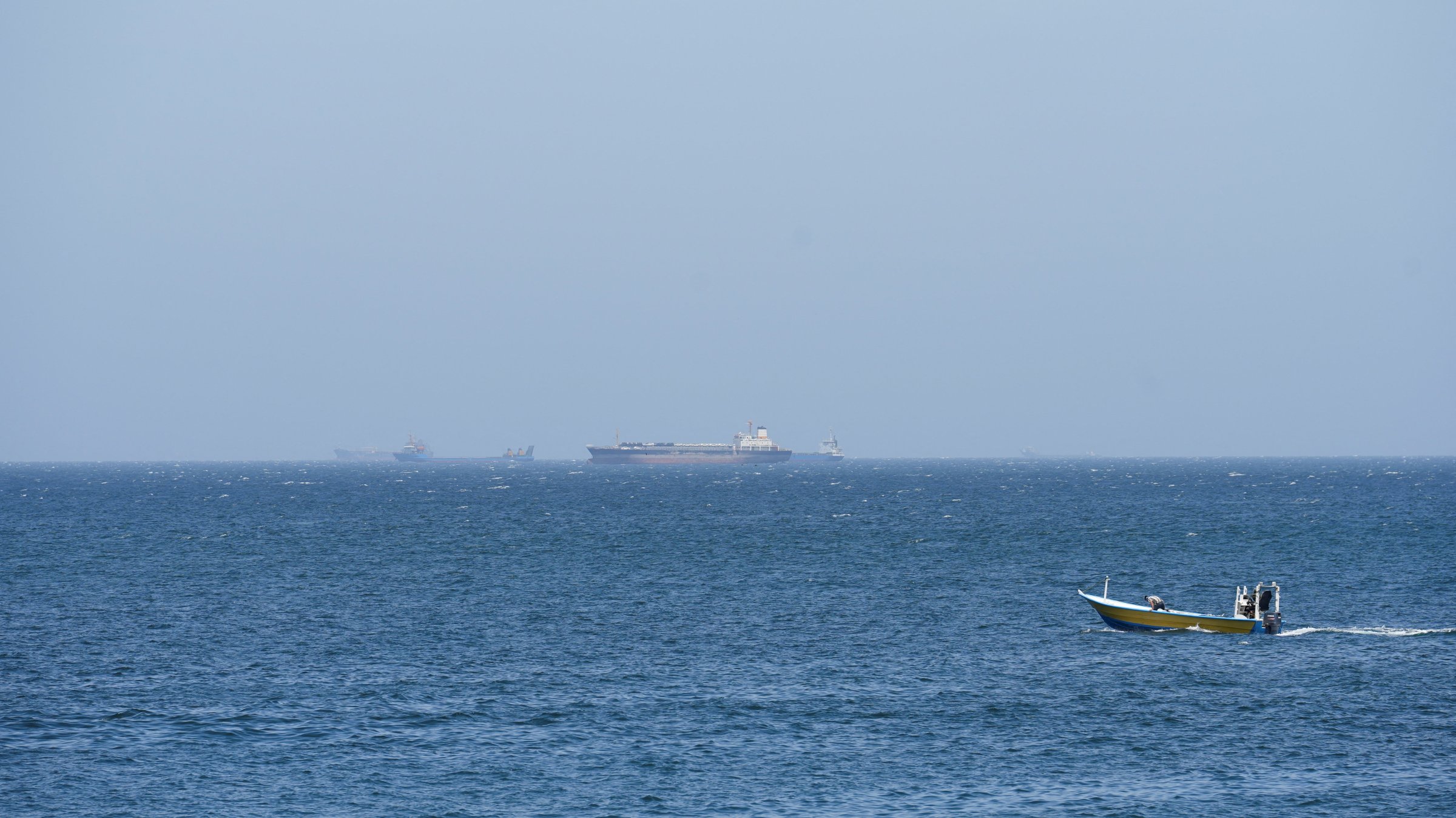 Vessels and boats are off the coast of Musandam governorate, overlooking the Strait of Hormuz, Oman, April 8, 2026. (Reuters Photo)