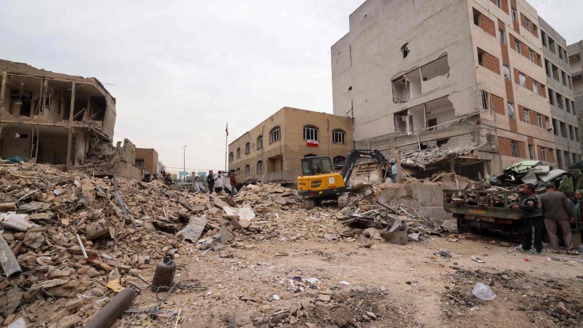 A digger removes debris following damage to a residential building in the Iranian capital Tehran, March 15, 2026. (AFP File Photo)