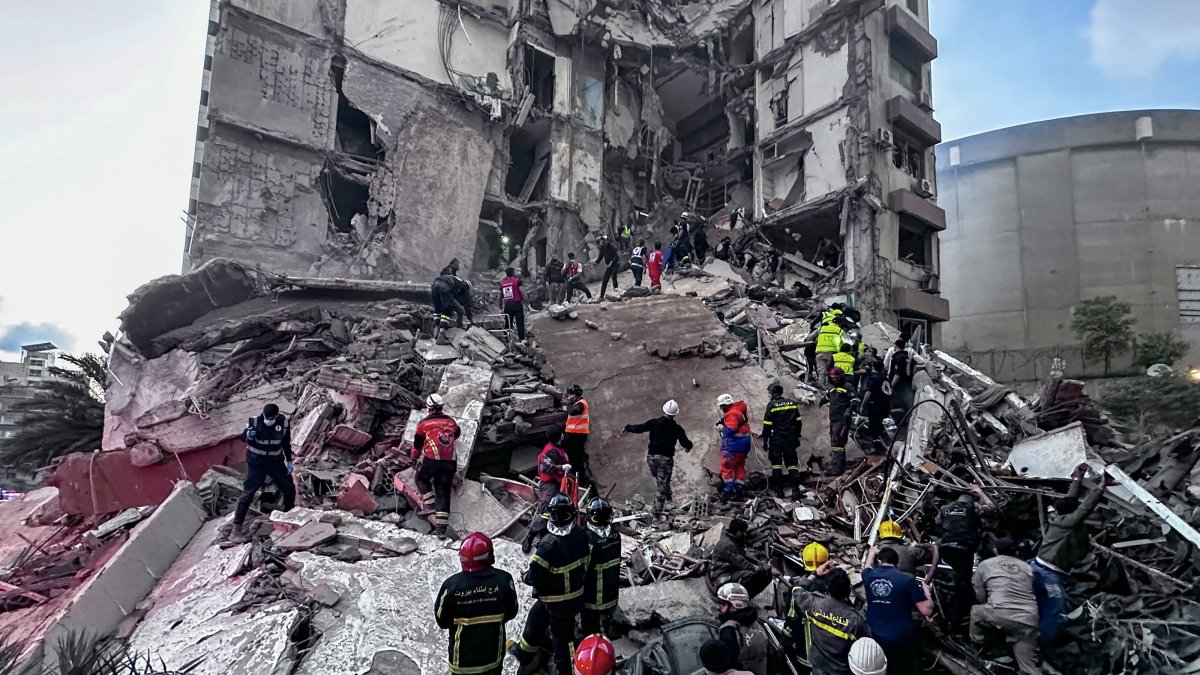 First responders search for missing people under the rubble of a partially destroyed residential building following an Israeli air strike, in the Tallet al-Khayat neighborhood of Beirut, Lebanon, April 8, 2026. (EPA Photo)