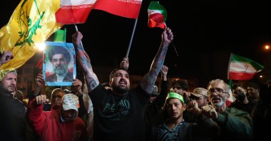 Iranians wave the country's flag and hold a portrait of Supreme Leader Mojtaba Khamenei following the announcement of a two-week cease-fire at in Tehran, Iran, April 8, 2026. (EPA Photo)
