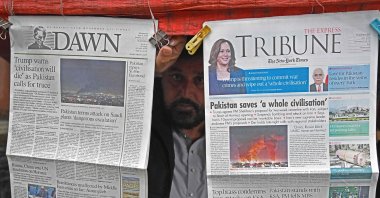 A vendor displays morning newspapers at his roadside stall in Islamabad, Pakistan, April 8, 2026. (AFP Photo)