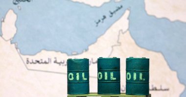 A map showing the Strait of Hormuz, also known as Madiq Hurmuz, and 3D printed oil barrels are seen in this illustration taken on March 26, 2026. (Reuters Photo)