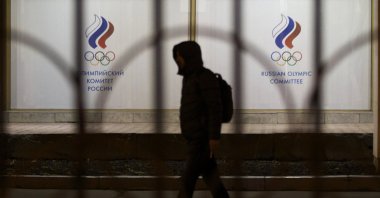 A man walks by the Russian Olympic Committee building, Moscow, Russia, Nov. 9, 2015. (AP Photo)