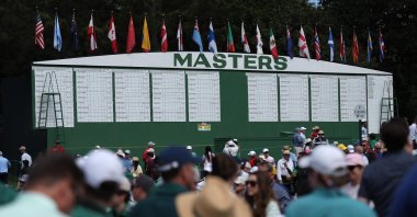 Patrons walk the grounds near the main leaderboard during a practice round before the 2026 Masters Tournament at Augusta National Golf Club, Augusta, U.S., April 7, 2026. (AFP Photo)