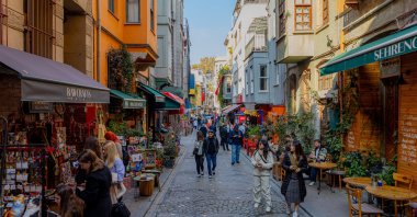 People walk on a historic street of the Balat district known for its colorful buildings, Istanbul, Türkiye, Nov. 2, 2024. (Shutterstock Photo)