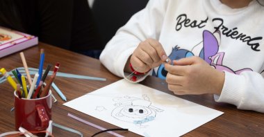 A child participates in a painting activity as part of an art workshop supporting creative development, Ankara, Türkiye, April 4, 2026. (AA Photo) 