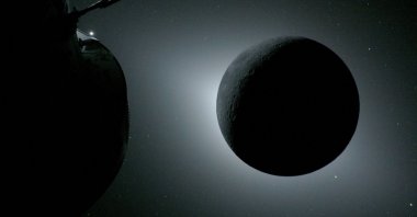 The Orion spacecraft (L) and the Moon backlit by the Sun during a solar eclipse on April 6, 2026. (AFP Photo)