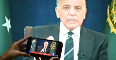 A resident listens on a mobile phone to an address to the nation by Pakistan’s Prime Minister Shehbaz Sharif about the ongoing U.S.-Israel war on Iran, in Islamabad, March 9, 2026.  (AFP File Photo)