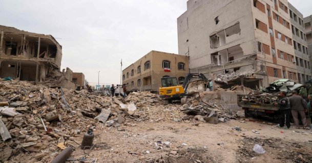 A digger removes debris following damage to a residential building in the Iranian capital Tehran, March 15, 2026. (AFP File Photo)