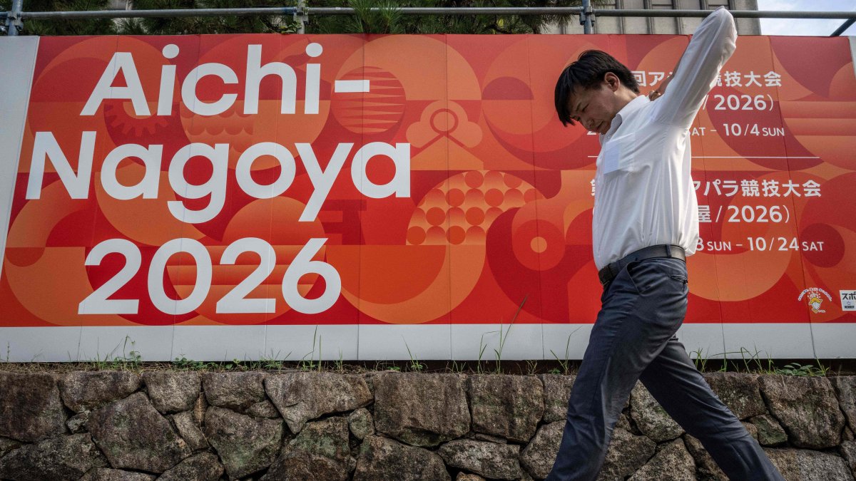A man walks past an advertisement for the 2026 Aichi-Nagoya Asian Games, Nagoya, Aichi prefecture, Japan, Sept. 8, 2025. (AFP Photo)