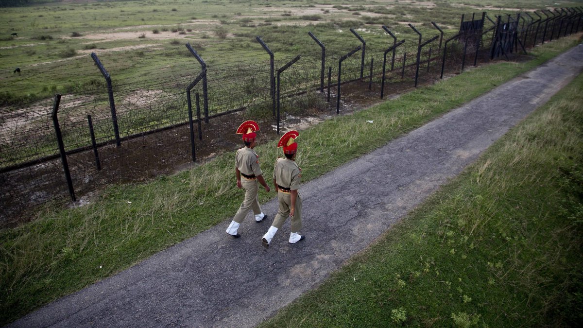 Indian Border Security Force personnel patrol near a fence on the India-Bangladesh border at Thakuranbari village, in Assam, northeastern India, Sept. 2, 2016. (AP Photo)