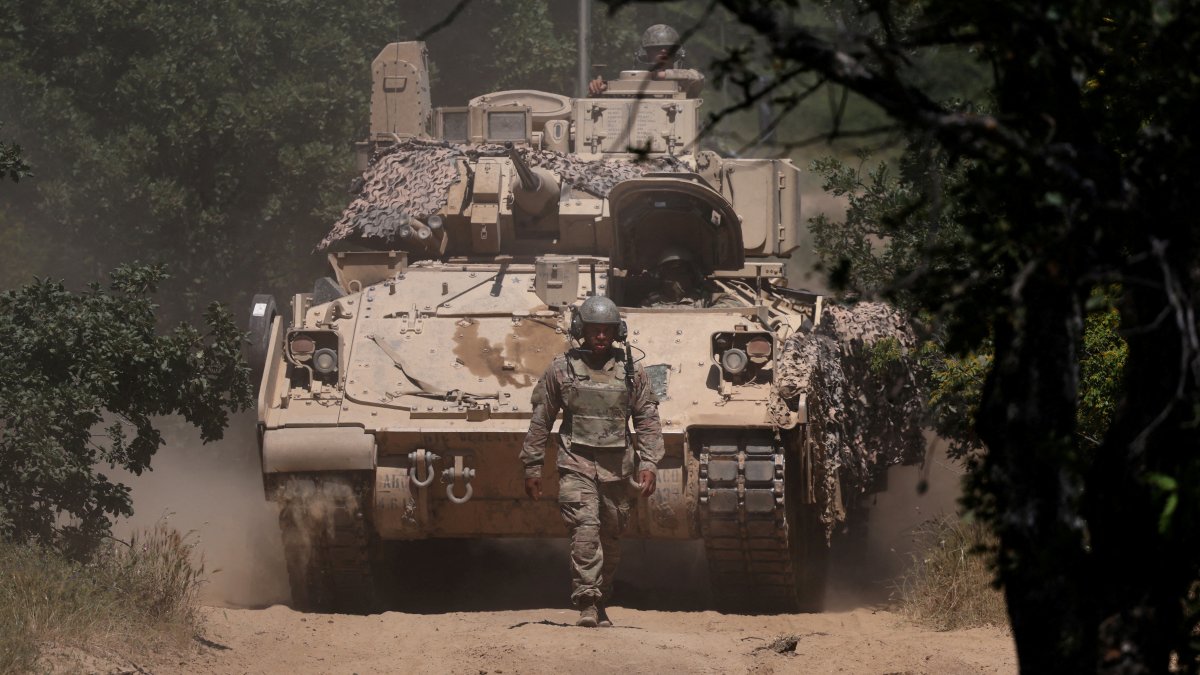 A U.S. soldier walks in front of an armoured vehicle during "Balkan Sentinel – 25" military drill, an exercise involving personnel and equipment from the Bulgarian Land Forces and Air Force, formations from the NATO Multinational Battle Group with Italy, and a mechanized platoon from the Romanian Land Forces, Koren, Bulgaria, June 9, 2025. (Reuters Photo)