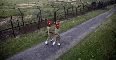 Indian Border Security Force personnel patrol near a fence on the India-Bangladesh border at Thakuranbari village, in Assam, northeastern India, Sept. 2, 2016. (AP Photo)