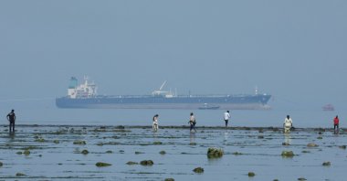 Tourists watch marine life, with the MT Desert Kite oil tanker carrying Russian oil in the background, at Narara Marine National Park in the Arabian Sea, Gujarat, India March 11 , 2026. (Reuters Photo)