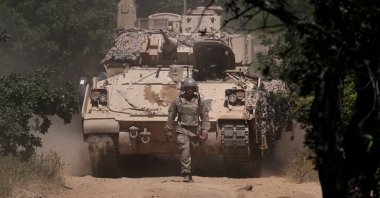 A U.S. soldier walks in front of an armoured vehicle during "Balkan Sentinel – 25" military drill, an exercise involving personnel and equipment from the Bulgarian Land Forces and Air Force, formations from the NATO Multinational Battle Group with Italy, and a mechanized platoon from the Romanian Land Forces, Koren, Bulgaria, June 9, 2025. (Reuters Photo)