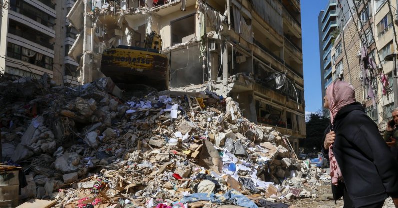 A woman watches as a bulldozer clears the rubble of a destroyed building the day after an Israeli airstrike in the Ain Mreisseh neighborhood of Beirut, Lebanon, April 9, 2026. (EPA Photo)