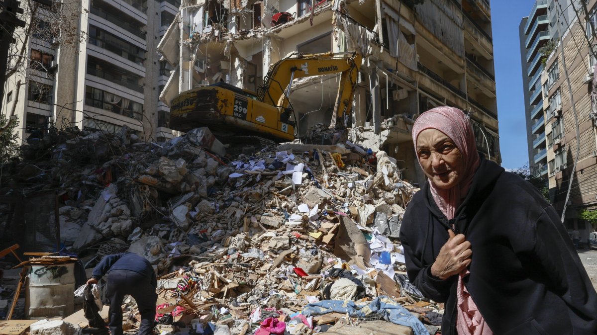 A woman walks next to a destroyed residential building the day after an Israeli airstrike in the Ain Mreisseh neighborhood of Beirut, Lebanon, April 91 2026. (EPA Photo)