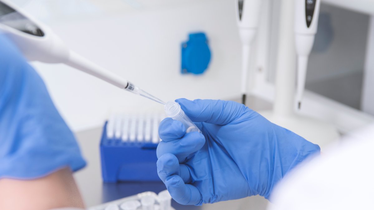 A doctor holds a blood tube test in the research laboratory. (Shutterstock Photo)