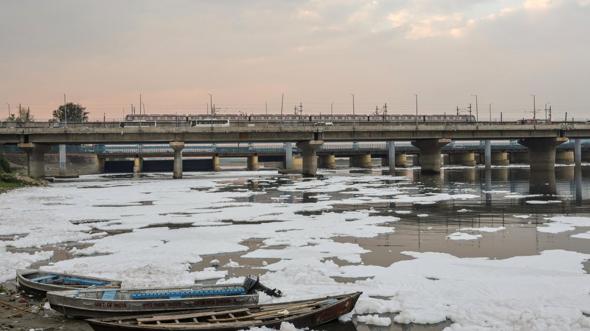 Boats sit amid toxic foam covering the Yamuna River in New Delhi, India, April 8, 2026. (EPA Photo)