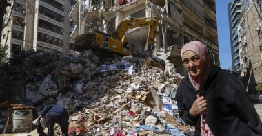 A woman walks next to a destroyed residential building the day after an Israeli airstrike in the Ain Mreisseh neighborhood of Beirut, Lebanon, April 91 2026. (EPA Photo)