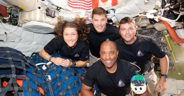 The NASA Artemis II crew, mission specialist Christina Koch, mission specialist Jeremy Hansen, commander Reid Wiseman and pilot Victor Glover, pose for a group photo inside the Orion spacecraft on their way home following a flyby of the far side of the moon, April 7, 2026. (Reuters Photo)