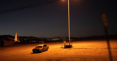 A driver sits in his car in an empty parking lot in Calama, Chile, April 14, 2023. (AP Photo)