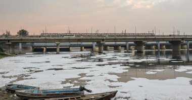 Boats sit amid toxic foam covering the Yamuna River in New Delhi, India, April 8, 2026. (EPA Photo)