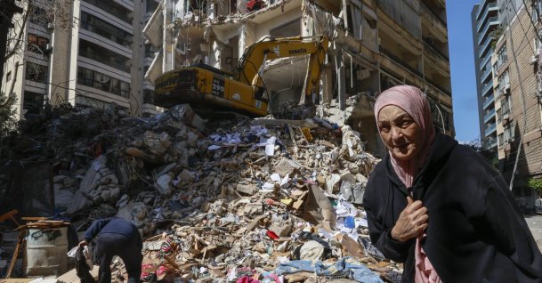 A woman walks next to a destroyed residential building the day after an Israeli airstrike in the Ain Mreisseh neighborhood of Beirut, Lebanon, April 91 2026. (EPA Photo)