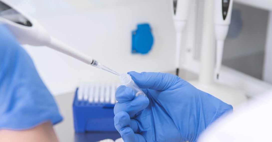A doctor holds a blood tube test in the research laboratory. (Shutterstock Photo)