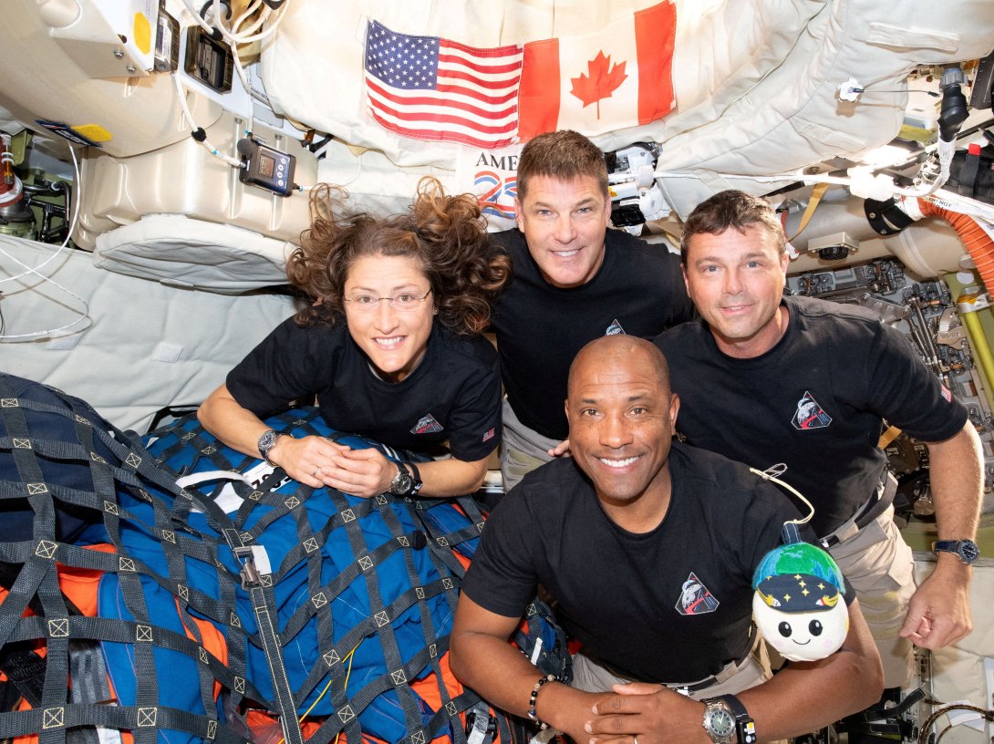 The NASA Artemis II crew, mission specialist Christina Koch, mission specialist Jeremy Hansen, commander Reid Wiseman and pilot Victor Glover, pose for a group photo inside the Orion spacecraft on their way home following a flyby of the far side of the moon, April 7, 2026. (Reuters Photo)