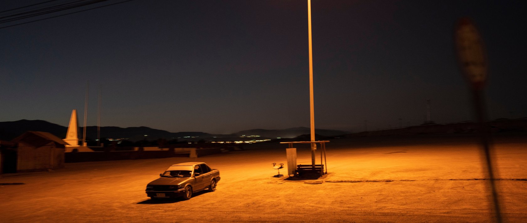 A driver sits in his car in an empty parking lot in Calama, Chile, April 14, 2023. (AP Photo)
