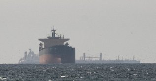 Cargo ships in the Gulf, near the Strait of Hormuz, as seen from northern Ras al-Khaimah, near the border with Oman’s Musandam governance, amid the U.S.-Israeli conflict with Iran, in United Arab Emirates, March 11, 2026. (Reuters Photo)