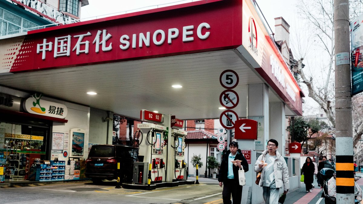 People walk past the SINOPEC petrol station, Shanghai, China, March 19, 2026. (EPA Photo)