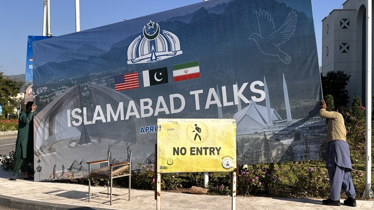 Workers remove billboards after the peace talks between U.S. and Iran ended in Islamabad, Pakistan, April 12, 2026. (EPA Photo)