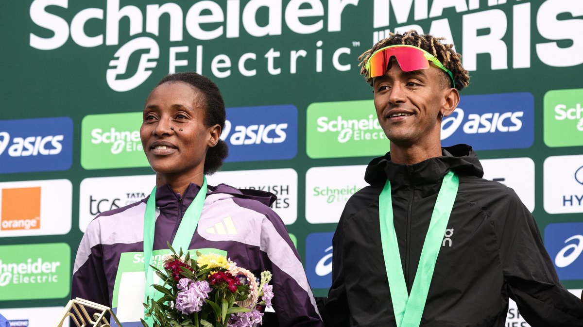 Winners Shure Demise from Ethiopia (L) and Yemaneberhan Crippa from Italy (R) pose on the podium of the Marathon de Paris 2026 in Paris, France, April 12, 2026. (EPA Photo)
