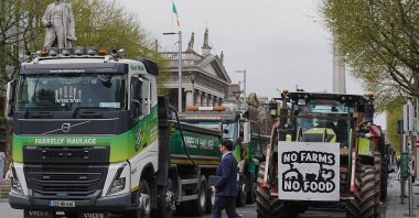 A man crosses a road where vehicles are parked on O'Connell Street, on the second day of a national fuel protest against rising fuel prices, Dublin, Ireland,  April 8, 2026. (AP Photo)