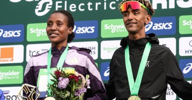 Winners Shure Demise from Ethiopia (L) and Yemaneberhan Crippa from Italy (R) pose on the podium of the Marathon de Paris 2026 in Paris, France, April 12, 2026. (EPA Photo)