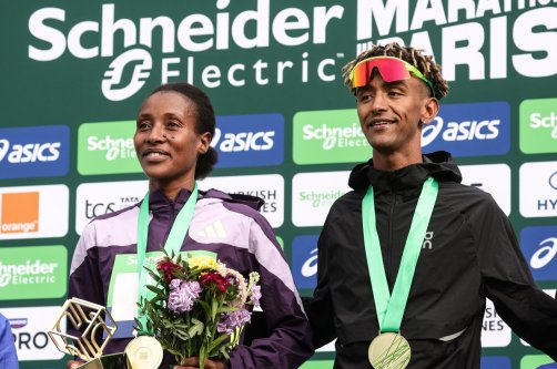 Winners Shure Demise from Ethiopia (L) and Yemaneberhan Crippa from Italy (R) pose on the podium of the Marathon de Paris 2026 in Paris, France, April 12, 2026. (EPA Photo)