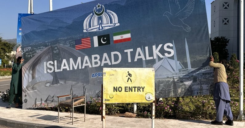Workers remove billboards after the peace talks between U.S. and Iran ended in Islamabad, Pakistan, April 12, 2026. (EPA Photo)