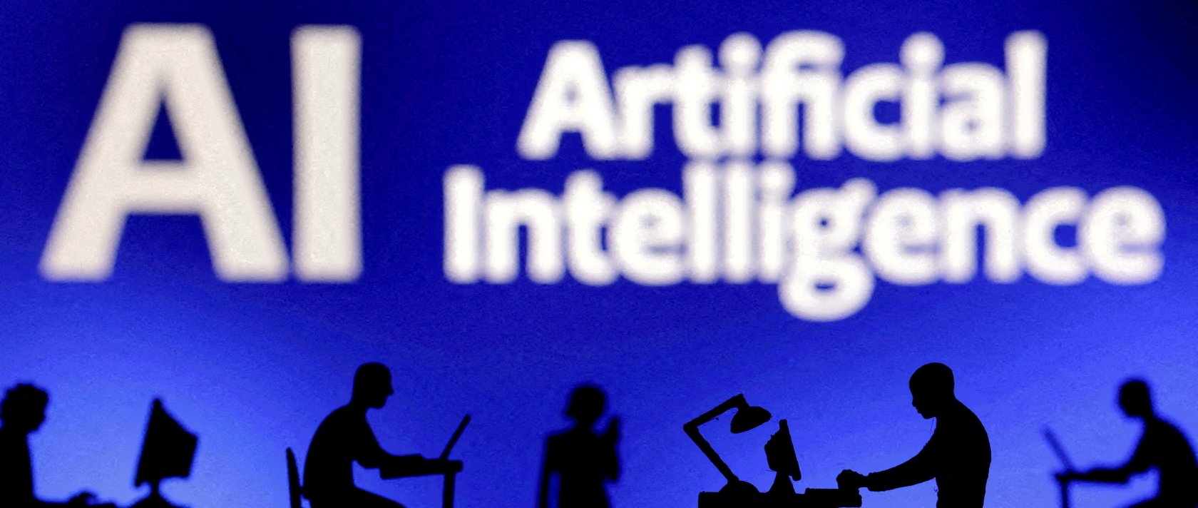 Figurines with computers and smartphones are seen in front of the words "Artificial Intelligence, AI" in this illustration created on Feb. 19, 2024. (Reuters Photo)